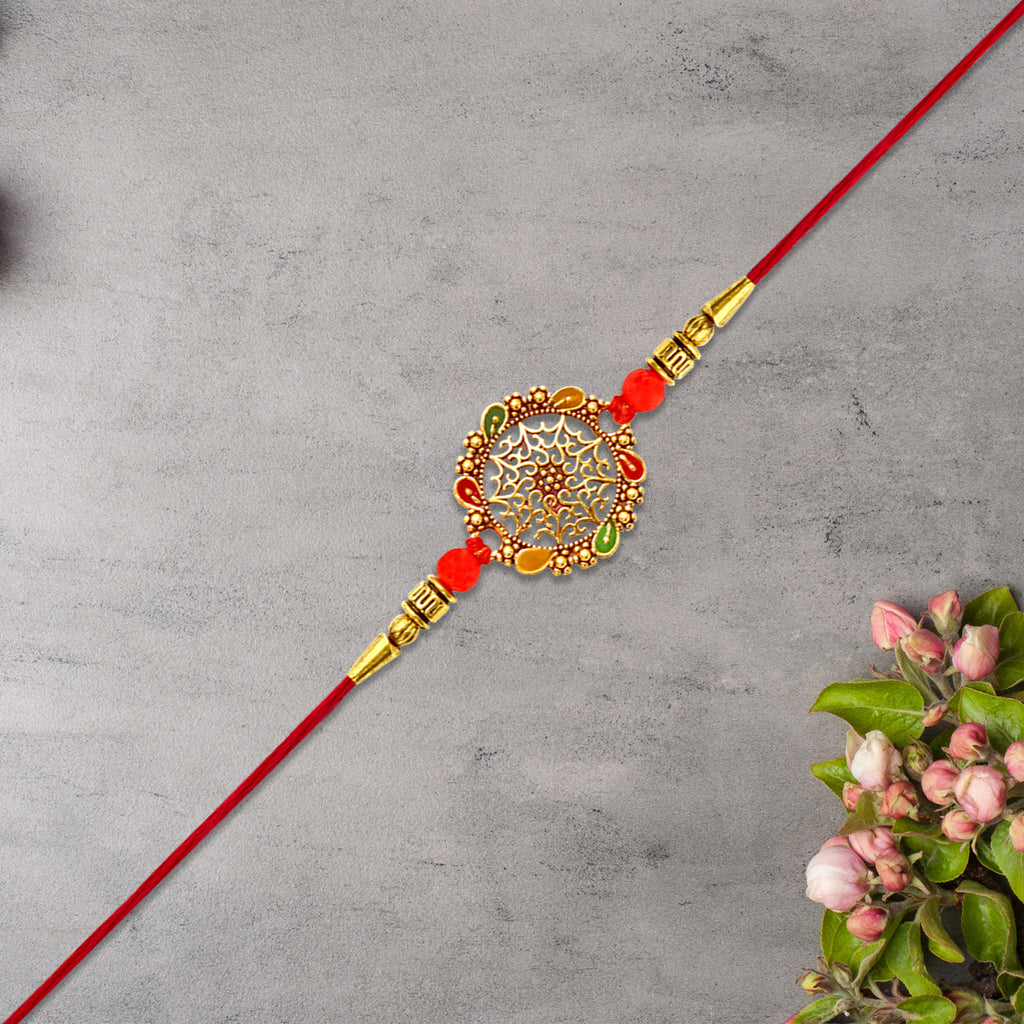 Intricately Designed Circular Rakhi With Multicolor Accents And Red Thread For Rakshabandhan