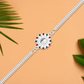 Elegant Silver-plated Floral Rakhi With Red And Green Meenakari Accents