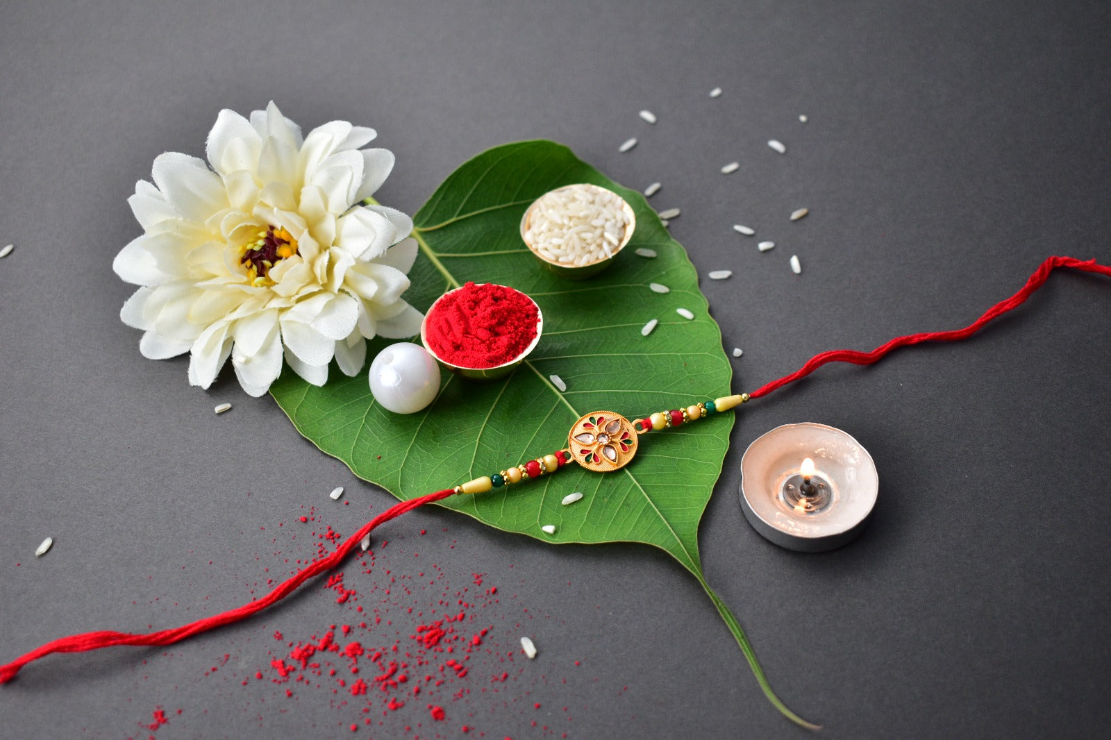 Sacred Kalash Design Rakhi With Embellished Beads And Red Thread