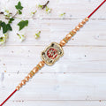 Om Rakhi With Stone Embellishments  Golden Beads
